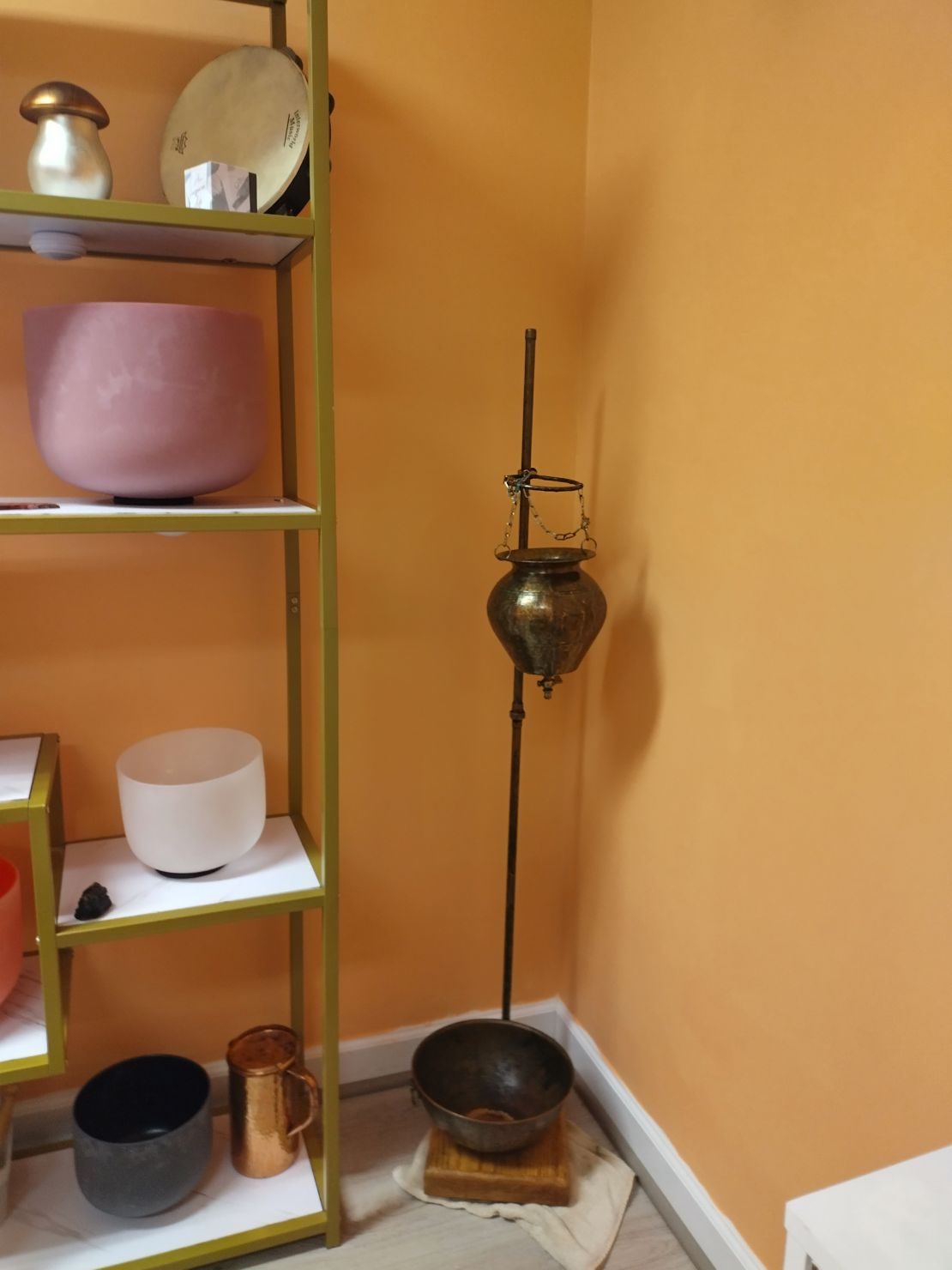 Crystal sound bowls on a shelf in the Healing Vibes studio