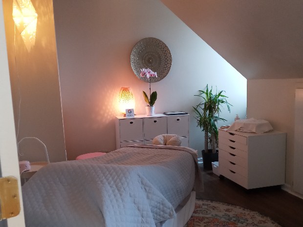 The softly lit Healing Vibes treatment room